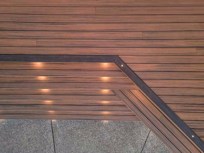 Composite decking boards with hidden fasteners and chamfered edges